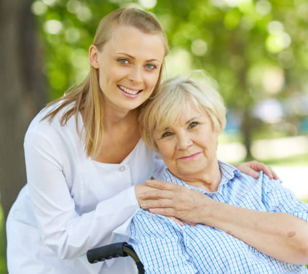 caregiver with woman in wheelchair